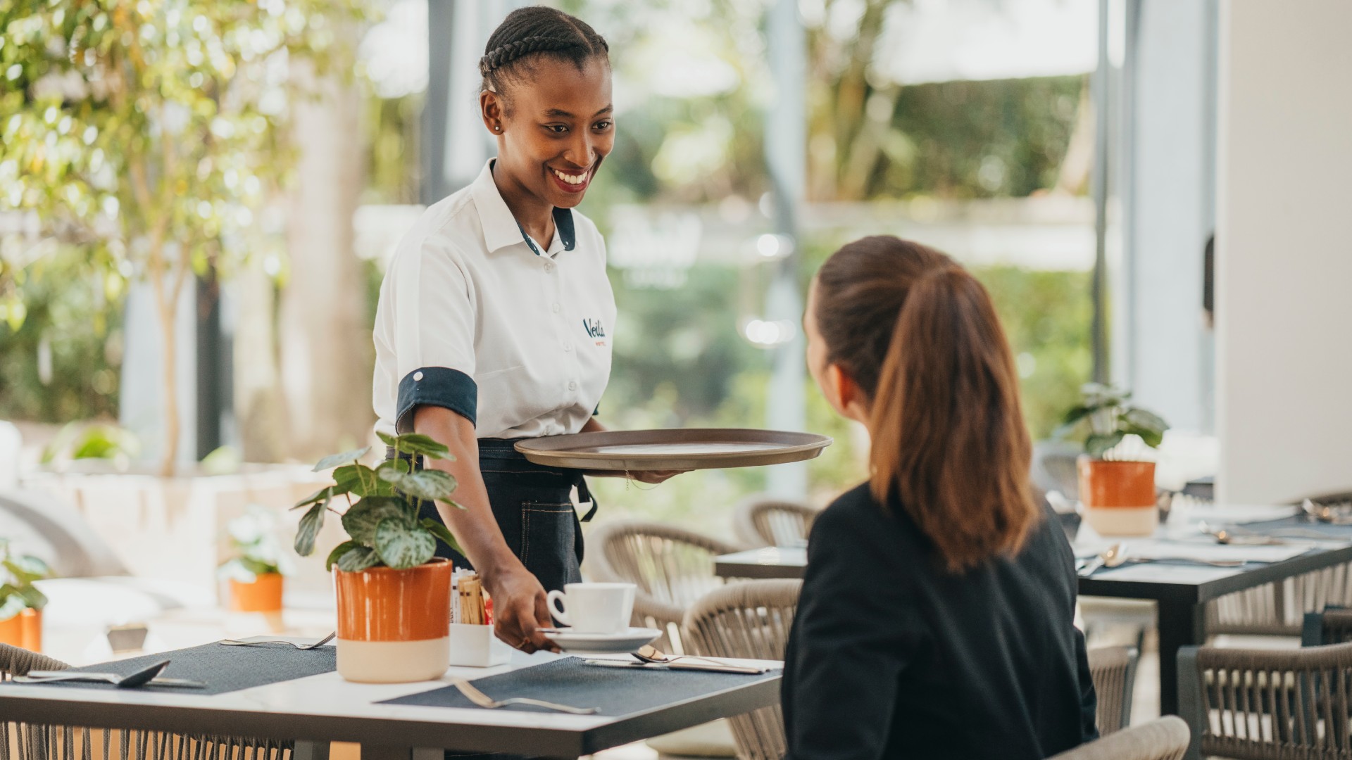 Person enjoying a coffee and practicing self-reflection at the restaurant in Voilà Hotel, Mauritius